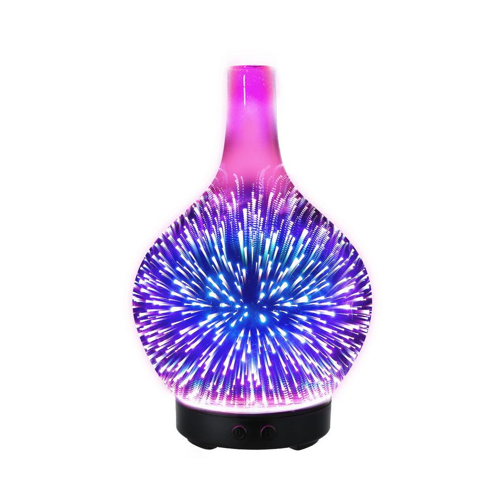 Glass essential oil diffuser with 3D fireworks LED light effect on white background